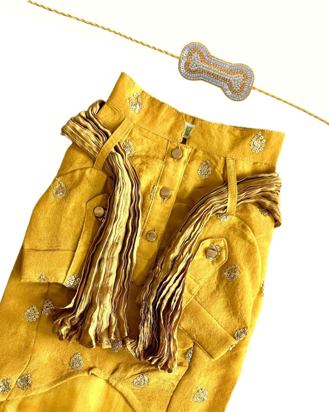 MUSTARD YELLOW TISSUE BUTI DOG KURTA+SILVER YELLOW PEARL BONE RAKHI FOR DOGS AND CATS
